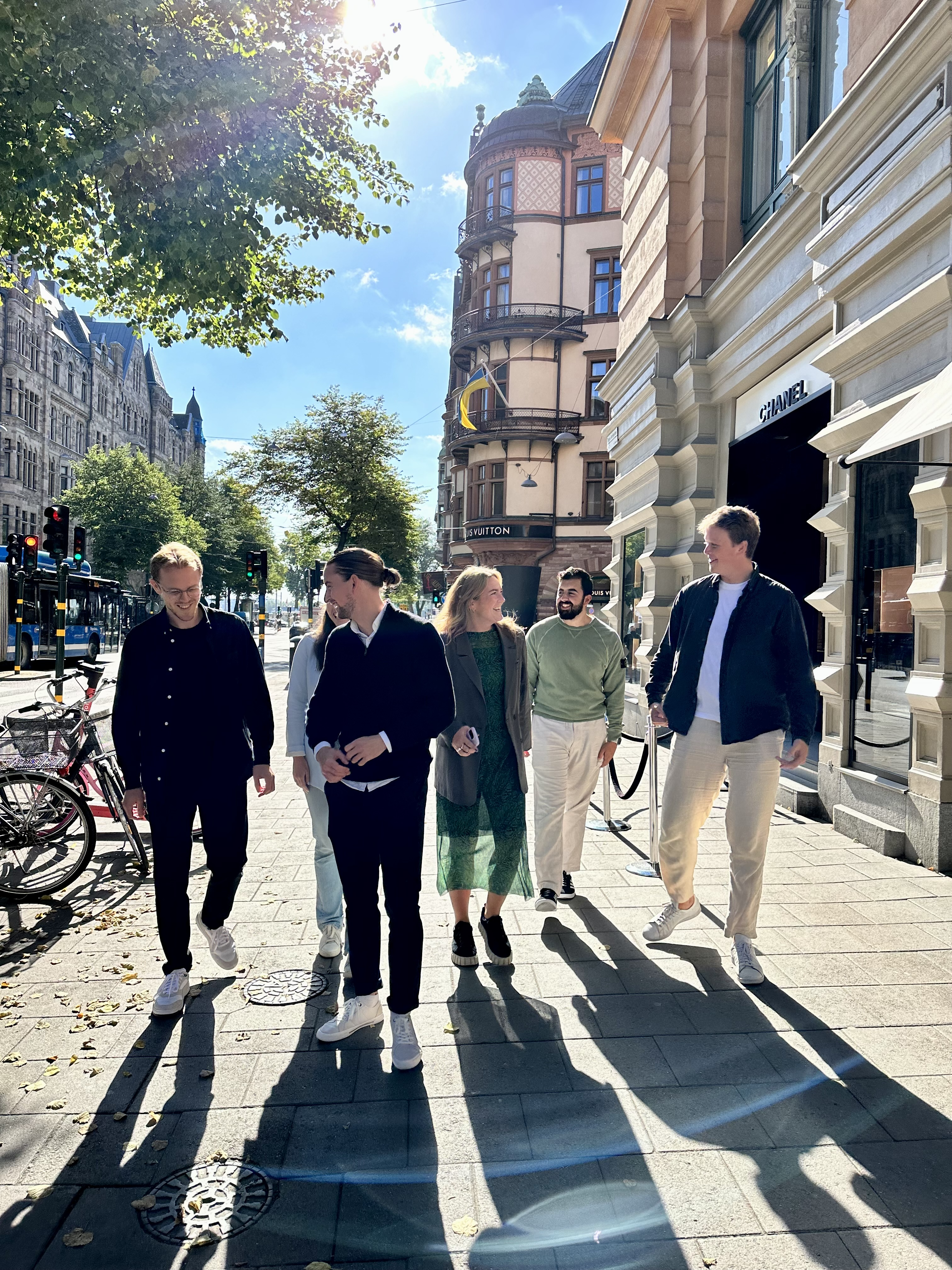 En grupp glada människor från Zington som går på en trottoar.